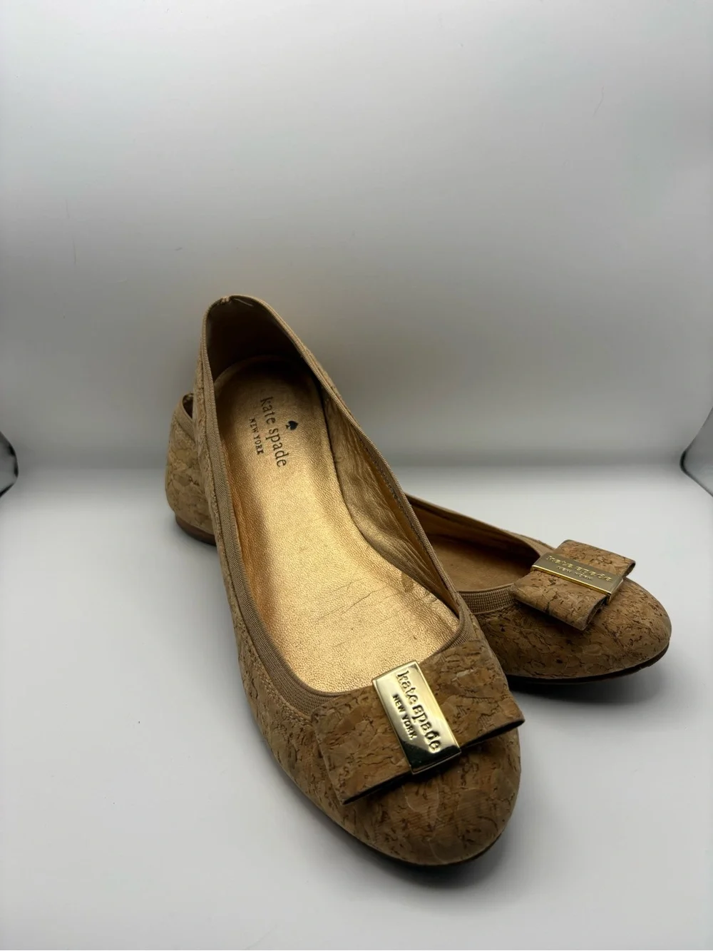 kate spade cork bow flats in tan with gold plaque
